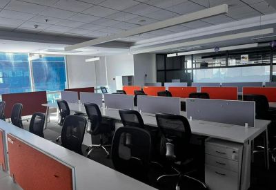 Open-plan workspace with black chairs and partitions.