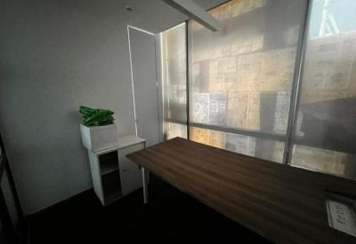 Private office with a wooden desk and frosted glass.