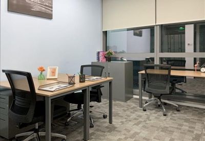 Contemporary breakout space with lime green chairs and private wooden work booths.