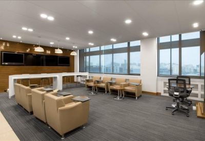 Modern lounge area with tan leather armchairs and a raised breakfast bar.