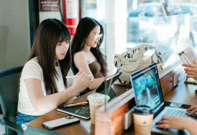Bright coworking area with glass partitions and wooden desks.
