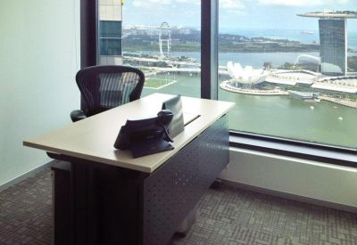 Private office suite with a desk overlooking the Singapore skyline and Marina Bay Sands.