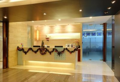 Brightly lit reception desk decorated with festive garlands.
