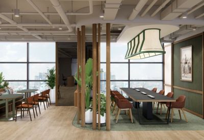 Communal dining area featuring a long dark table and green feature wall.