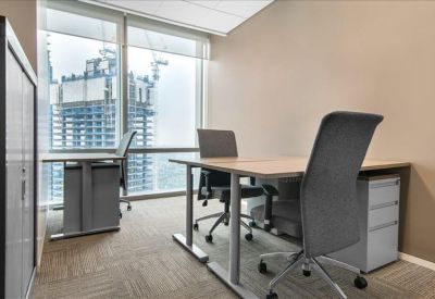 Bright private office suite with two desks and large windows overlooking the city.