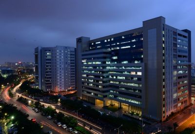 Exterior dusk view of the modern Maximus Tower 2A Raheja Mindspace IT Park Madhapur building.