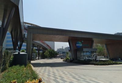 Covered walkway and main entrance gate with signage.