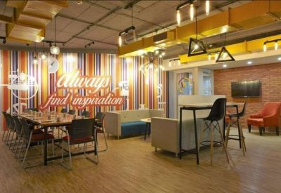 Lounge area with striped feature wall, long dining table, and various seating options.