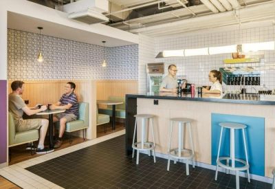 Reception and refreshment counter with pastel blue accents and comfortable booth seating.