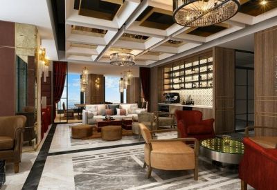 Luxury breakout lounge with velvet armchairs and a designer coffered ceiling.