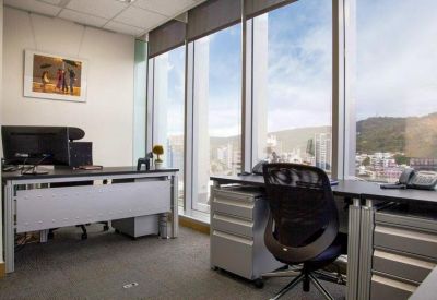 Private office with two desks and a scenic mountain view through large windows.