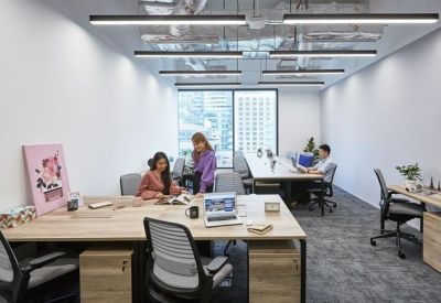 Private office suite with workstations for three and bright natural light.