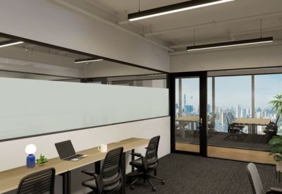 Internal office desk setup with glass partitions and city views in the background.