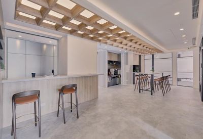 Spacious communal breakout area with a long breakfast bar and wooden lattice ceiling.