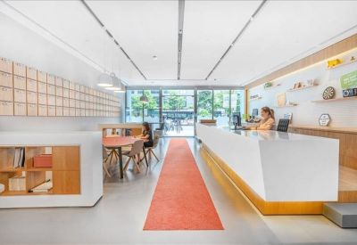 Collaborative meeting space framed by floor-to-ceiling wooden shelving units.