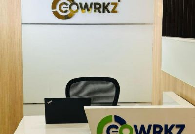 Reception area with branded signage and a white minimalist front desk.