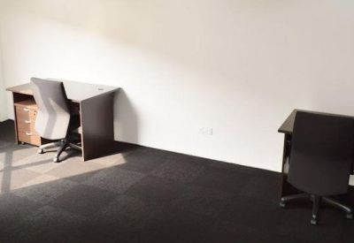 Two desks with chairs in a private office.