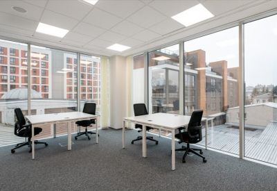 Private office with two desks and large windows.