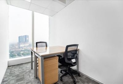 Bright corner private office with a desk, two chairs, and floor-to-ceiling windows.