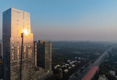 Skyscraper view with reflective glass windows and a cityscape background.