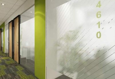 Bright office corridor with lime green accent walls and frosted glass doors.