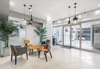 Bright lobby with glass entrance doors and contemporary pendant lighting.