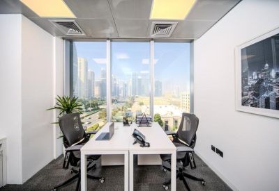 Private two-person office suite with white desks and floor-to-ceiling windows.
