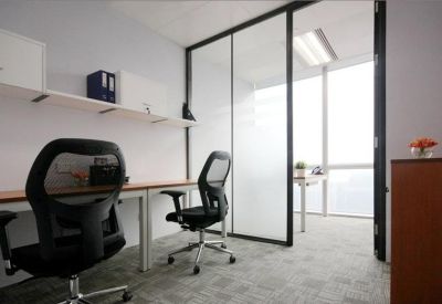 Private office suite with two mesh chairs and a frosted glass partition.