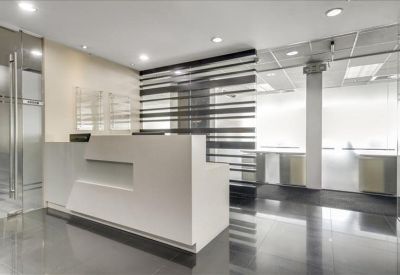 Minimalist white reception desk with a contemporary textured divider wall.
