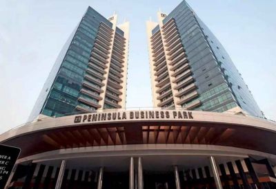 Low-angle exterior view of the modern glass towers at Peninsula Business Park.