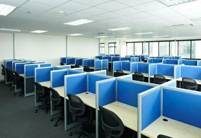 Spacious open-plan workspace at Picadilly Star with blue cubicle partitions and bright ceiling lights.