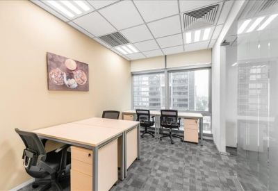 Bright private office suite with two workstations and window views.