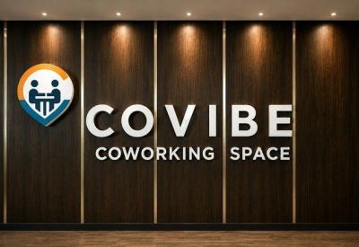 Wood-paneled feature wall with the company brand name under warm spotlighting.