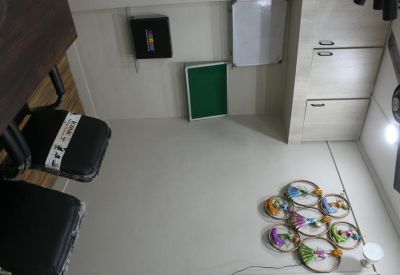 Overhead view of an office floor with circular decorative floor mats and white storage cabinets.