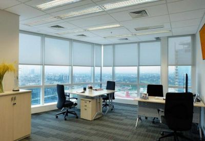 Bright corner office suite with floor-to-ceiling windows and city views.