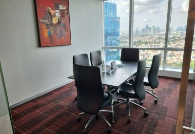 Professional meeting room with a dark table and city views through large windows.