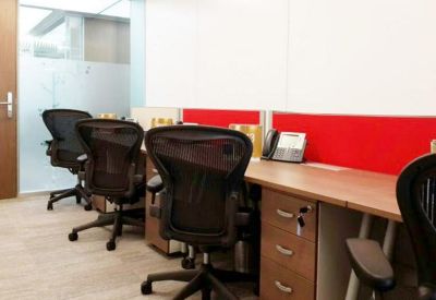 Office suite with shared wooden desks, red dividers, and black mesh chairs.