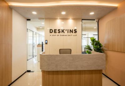 Sleek reception desk with a marble-style finish and company branding.