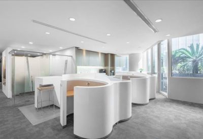 Unique communal area featuring white semi-circular privacy booths and grey carpets.