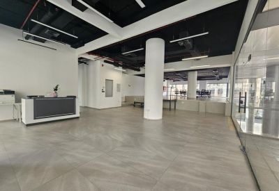 Minimalist reception area with a sleek desk, white columns, and a polished tile floor.