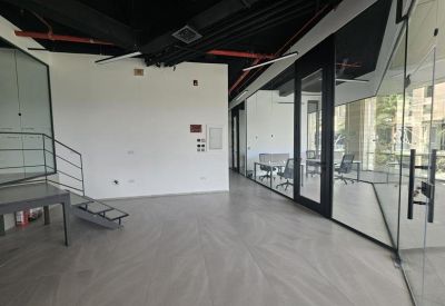 Spacious reception area with glass walls and access to stairs.