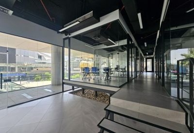 Glass-walled conference room on a raised platform with outdoor views.