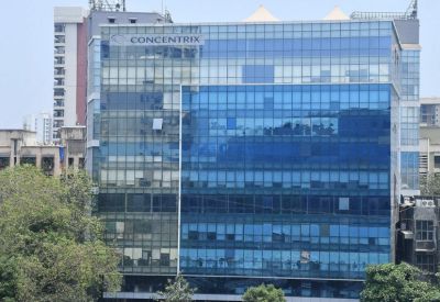 Daytime exterior view of a modern glass-paneled commercial building.