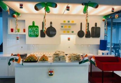 Communal kitchen area decorated with Indian flags and festive green balloons.