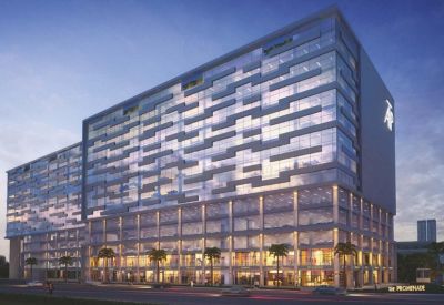 Dusk view of the modern glass facade at Redbrick Offices, Amar Tech Park, Balewadi with lighted ground floor retail.