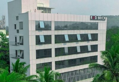 Exterior view of the white facade and glass windows at Redbrick Offices, BSB Capital, Aundh.