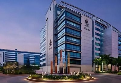 Exterior view of Redbrick Offices, Bangalore with modern glass facade and landscaped entrance.
