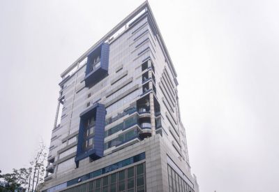Low-angle exterior of the modern Redbrick Offices, Infinity Benchmark building with blue framed architectural accents.