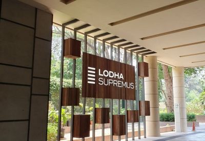 Entrance to Redbrick Offices, Lodha Supremus, Kolshet Rd with a wooden sign and greenery.