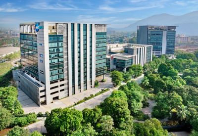 High-angle exterior view of the modern glass buildings at Redbrick Offices, Mindspace Juinagar.